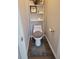 Small toilet room with white toilet and wood-look floors at 104 Worthy Drive, Mcdonough, GA 30252