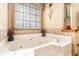 Bathroom showcasing a large jacuzzi tub with jets and floral accents at 1824 Colonial South Sw Dr, Conyers, GA 30094