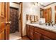 Bathroom featuring wood cabinets, a marble countertop, and ample counter space at 1824 Colonial South Sw Dr, Conyers, GA 30094