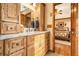 Bathroom featuring wood cabinetry, marble countertop, and neutral-toned decor at 1824 Colonial South Sw Dr, Conyers, GA 30094