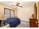 Bedroom with bright natural light, a side table, and blue bedding at 1824 Colonial South Sw Dr, Conyers, GA 30094