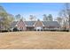 Beautiful brick home featuring a large manicured lawn and symmetrical design, exuding classic charm at 1824 Colonial South Sw Dr, Conyers, GA 30094