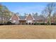 Lovely brick home showcasing symmetrical design, complemented by lush landscaping and a well-maintained lawn at 1824 Colonial South Sw Dr, Conyers, GA 30094