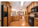 Spacious kitchen featuring wood cabinets, granite countertops, and modern black appliances at 1824 Colonial South Sw Dr, Conyers, GA 30094