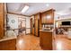 Traditional kitchen with wood cabinets, granite countertops, and wood floors at 1824 Colonial South Sw Dr, Conyers, GA 30094