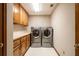 Laundry room featuring washer and dryer with plenty of cabinet storage at 1824 Colonial South Sw Dr, Conyers, GA 30094