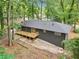 Exterior view of backyard showcasing wooden deck and lush, green trees that offer shade and privacy to the space at 2210 Bolling Brook Sw Dr, Atlanta, GA 30311