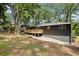 Exterior view of home showcasing backyard with wooden deck and lush landscaping, offering a peaceful outdoor space at 2210 Bolling Brook Sw Dr, Atlanta, GA 30311