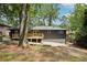 Exterior view of home featuring backyard with a wooden deck, complemented by mature trees for a private setting at 2210 Bolling Brook Sw Dr, Atlanta, GA 30311