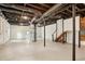 Spacious unfinished basement area with stairs and painted floors and walls at 2210 Bolling Brook Sw Dr, Atlanta, GA 30311