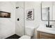 Bathroom with black fixtures, marble tile, and a flower picture at 2210 Bolling Brook Sw Dr, Atlanta, GA 30311