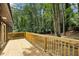 Spacious wooden deck overlooking a lush, green, tree-filled backyard and surrounding landscape at 2210 Bolling Brook Sw Dr, Atlanta, GA 30311