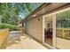 Wooden deck with sliding glass doors that lead to a dining room with views of the yard and trees at 2210 Bolling Brook Sw Dr, Atlanta, GA 30311