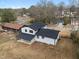 Aerial view of a home with a covered patio, black trim, and a spacious backyard at 2385 Tiffany Pl, Decatur, GA 30035