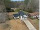 Aerial view of home with black roof, garage, fenced yard, and driveway in mature neighborhood at 2385 Tiffany Pl, Decatur, GA 30035