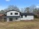 White two-story house boasts a covered patio, black trim, and a spacious backyard at 2385 Tiffany Pl, Decatur, GA 30035