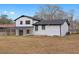 White two-story home featuring a covered patio, black trim, and a spacious backyard at 2385 Tiffany Pl, Decatur, GA 30035