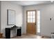 Entryway with neutral walls, black console table, and light wood door featuring glass panes at 2385 Tiffany Pl, Decatur, GA 30035