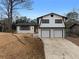 Charming updated two-story home with white brick, black trim, and an attached two-car garage at 2385 Tiffany Pl, Decatur, GA 30035