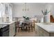 Open floor plan with updated kitchen flowing into a dining area with modern light fixtures at 2385 Tiffany Pl, Decatur, GA 30035