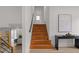 Staircase with wood treads, white walls, black handrail, and view into living room at 2385 Tiffany Pl, Decatur, GA 30035