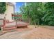 Wooden deck with a stone patio leading to an archway in a wooded backyard at 274 Westchester Club Dr, Hiram, GA 30141