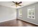 Cozy bedroom with hardwood floors, ceiling fan, and two windows offering lots of natural light at 274 Westchester Club Dr, Hiram, GA 30141