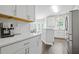 Contemporary white kitchen with stainless steel appliances, white countertops, and natural light from a window at 274 Westchester Club Dr, Hiram, GA 30141