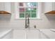 Farmhouse sink with modern faucet featured against white subway tiles and white countertops at 274 Westchester Club Dr, Hiram, GA 30141