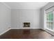 Spacious living room featuring a white brick fireplace and large bright window at 274 Westchester Club Dr, Hiram, GA 30141