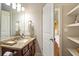 Well-lit bathroom featuring granite countertops, modern fixtures, and ample storage at 3830 Deer Run Dr, Cumming, GA 30028