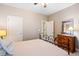 Comfortable bedroom with neutral tones, a decorative mirror, and lots of natural light at 3830 Deer Run Dr, Cumming, GA 30028