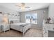 Comfortable bedroom with bright window, ceiling fan and decorative wall shelves at 3830 Deer Run Dr, Cumming, GA 30028