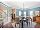 Elegant dining room with beautiful blue walls, wainscoting and dark table set for four at 3830 Deer Run Dr, Cumming, GA 30028