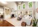 Bright living room with a fireplace, built-in shelving, and lots of natural light from the large windows at 3830 Deer Run Dr, Cumming, GA 30028