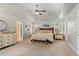 Spacious main bedroom featuring a tray ceiling, sitting bench and neutral carpet at 3830 Deer Run Dr, Cumming, GA 30028