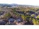 Aerial view of home nestled among the trees in a residential neighborhood at 1165 Pin Oak Ct, Cumming, GA 30041