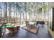 Outdoor deck with beautiful view of the wooded backyard and an outdoor dining set at 1165 Pin Oak Ct, Cumming, GA 30041