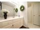 Well-lit bathroom with a large mirror and classic vanity at 1165 Pin Oak Ct, Cumming, GA 30041