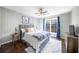 This bedroom features a comfortable bed with a ceiling fan and a view outside the window at 1165 Pin Oak Ct, Cumming, GA 30041