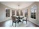 Sun-filled breakfast nook with large windows and a round table with seating for four at 1165 Pin Oak Ct, Cumming, GA 30041