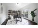 Bright dining room with a round table set, decorative shelving, and a large window providing ample light at 1165 Pin Oak Ct, Cumming, GA 30041