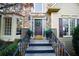 Charming home entrance with stone facade, decorative wreath, and well-manicured landscaping at 1165 Pin Oak Ct, Cumming, GA 30041