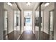 Hallway with mirrored closet doors leading to bathroom at 1165 Pin Oak Ct, Cumming, GA 30041