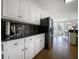 Modern kitchen featuring white cabinets, stainless appliances, granite countertops, and seamless access to the dining area at 1165 Pin Oak Ct, Cumming, GA 30041