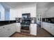 Well-lit kitchen features white cabinetry, granite countertops, stainless steel appliances, and tiled backsplash at 1165 Pin Oak Ct, Cumming, GA 30041