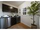 Bright laundry room with modern appliances and ample storage cabinets at 1165 Pin Oak Ct, Cumming, GA 30041