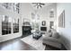 Light-filled living room with a fireplace, large windows, and modern decor creating a relaxing space at 1165 Pin Oak Ct, Cumming, GA 30041