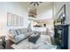 Open concept living room with a fireplace, neutral tones, and seamless flow into the kitchen area at 1165 Pin Oak Ct, Cumming, GA 30041