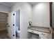 Bathroom vanity with granite countertop and a water closet through an open white door, adding convenience and privacy at 2117 Hwy 101 N, Dallas, GA 30157